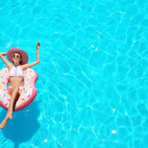 woman in sun hat on a tube in swimming pool